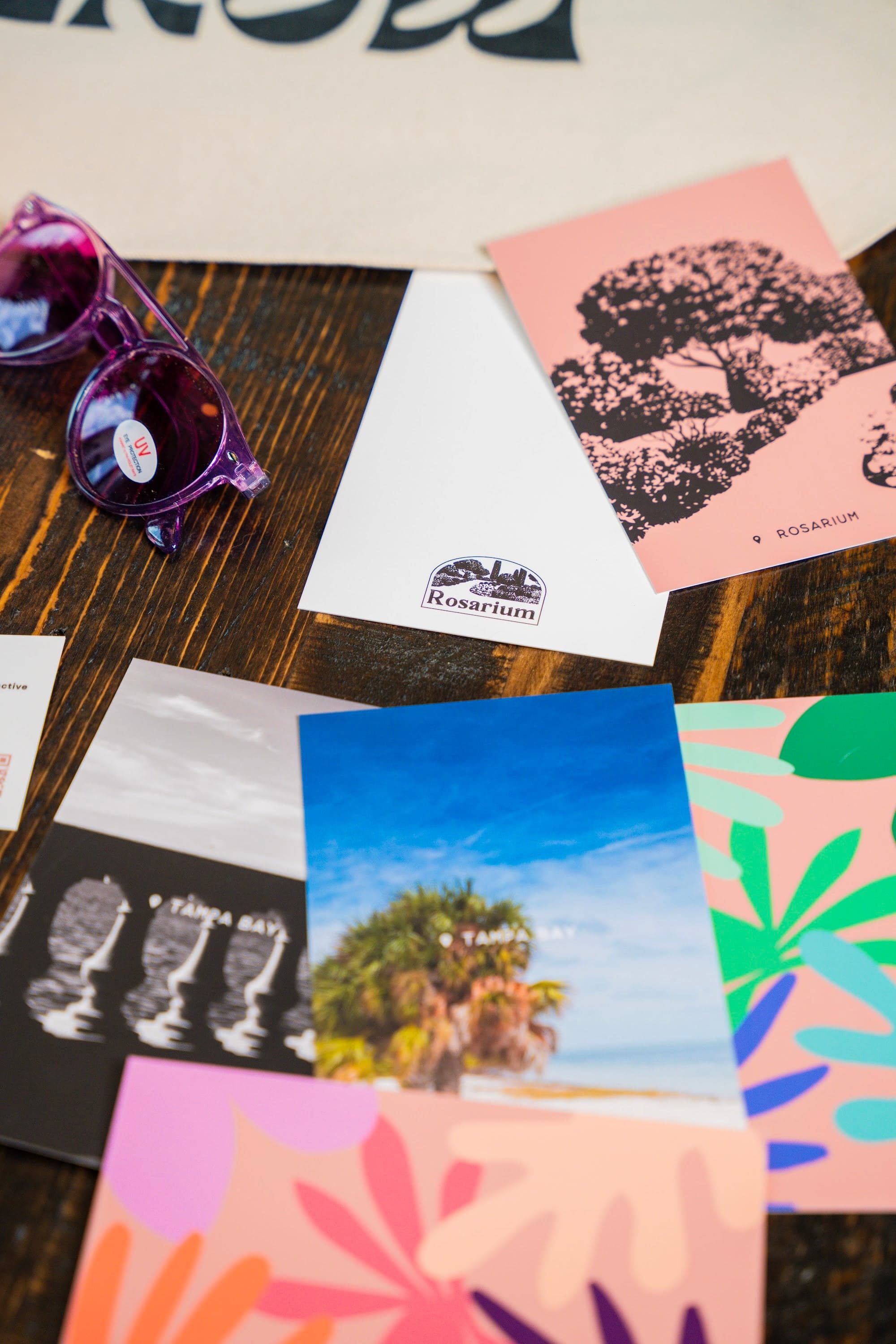 Rosarium branded flat-lay — On The Grow print, florals, and brand pieces