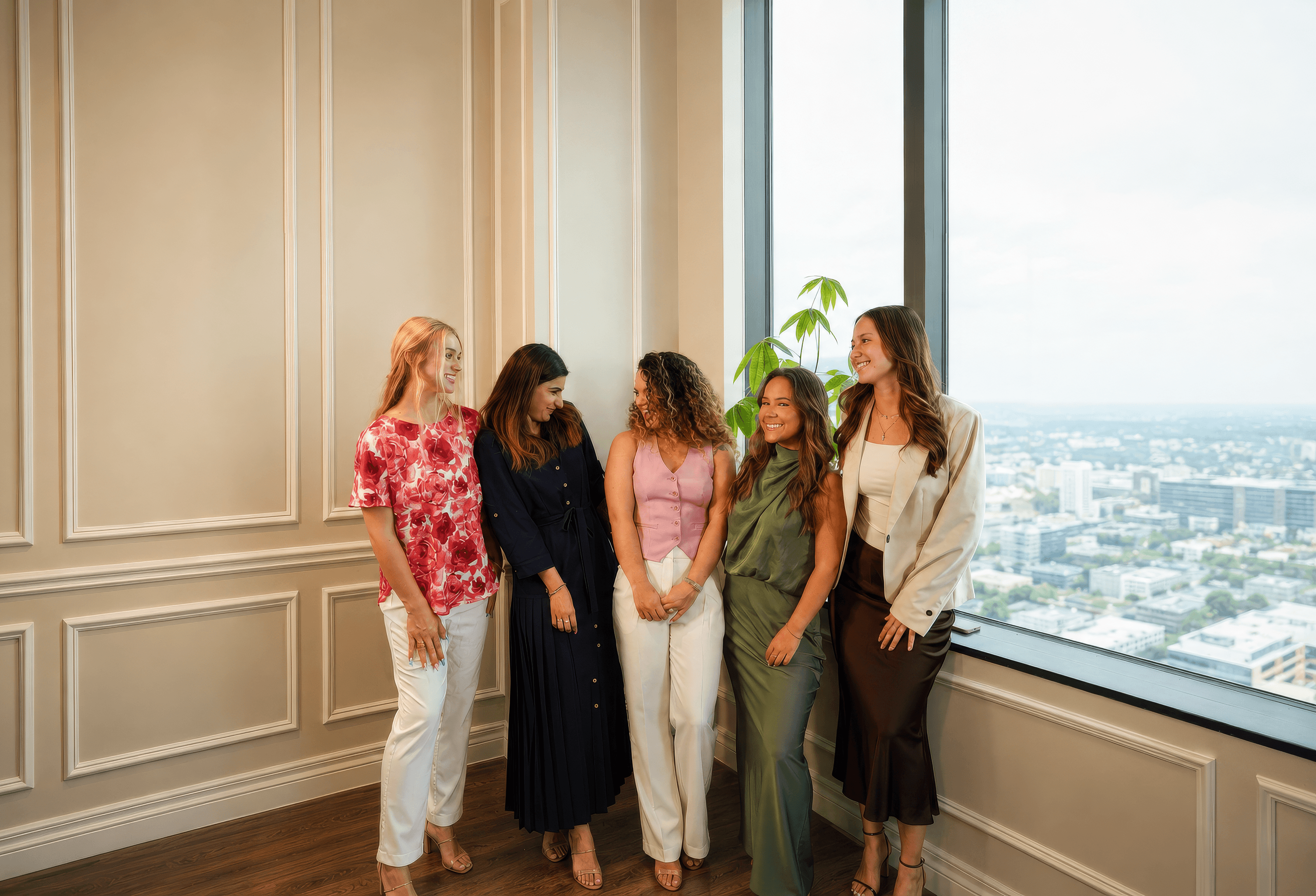 The Rosarium Collective team — five women in a sunlit office overlooking the city